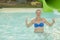 Happy girl in bikini sliding water park. Woman in a blue swimsuit. toned.