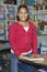 Happy Girl With Book In Classroom