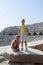 happy girl and boy on giant slabs of ancient amphitheatre in Side, Turkey