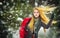 Happy girl with cap and gloves playing with snow in the winter landscape