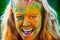 Happy girl celebrate festival Holi. Portrait of happy young girl on holi color festival.