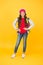 Happy girl child in casual fashion style listen to music playing in modern headphones yellow background, leisure