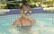 Happy girl child wear swimming mask in outdoor pool in summer, swim
