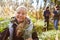 Happy girl with conifer for afforestation in the forest