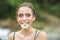 Happy girl with daisy flower in mouth