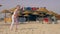 Happy girl dancing on summer beach on background international flags