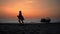 Happy girl in the dress jumping on the beach at the sunset