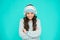 Happy girl enjoy winter playlist. music mood. cheerful little child knitted sweater and hat. smiling kid turquoise