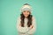 Happy girl enjoy winter playlist. music mood. cheerful little child knitted sweater and hat. smiling kid turquoise
