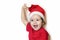 Happy girl in festive clothes and santa claus hat. Cute baby in Christmas clothes waits and enjoys the holiday.