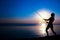 A Happy girl fisherman catches fish by the sea on nature silhouette travel