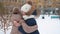 Happy girl friends meeting on snowy street at winter street in city. School girl hugging while outdoor meet on winter