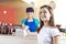 Happy Girl Giving Dollar Note To Waitress In Ice Cream Parlor