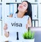 Happy girl holding a poster with the inscription visa. Young girl received a work visa in the United States. Girl