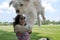 Happy girl holding a young Havanese dog