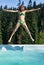 Happy girl jumps into swimming pool in shape of star