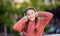 Happy girl listening to music. Teenage girl smiling while listening to headphones