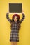 Happy girl with long curly hair in beret. child with empty blackboard. parisian child on yellow. copy space. promotion