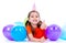 Happy girl lying on the floor with colorful balloons.