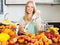 Happy girl making fruits cocktail with electric blender