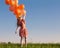 Happy girl with orange balloons