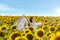 Happy girl outdoors in spring sunflower field