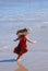 Happy girl playing on the beach