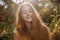 Happy girl posing in front of high grass in a park with her eyes closed retro color