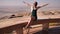 Happy girl posing on top near the city of Al Ain. United Arab Emirates.