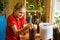 Happy girl pours soil into plastic bottles cut off under a pot for garden plants