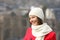 Happy girl in red looking away outdoors in winter