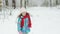 Happy girl running on snow in winter. Child girl are having a fun running between snow trees in winter time, happiness