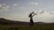 A happy girl runs across the field and holds a white handkerchief in her hand.