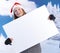 Happy girl in santa hat holding huge letter