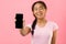 Happy girl showing blank screen smartphone, mockup for advertisement