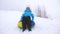 Happy girl slides through snow on sled, beautiful young woman slides down slide in snow on an inflatable snow tube and