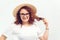 Happy girl in summer hat looking to camera. Student girl in eyeglasses on white background