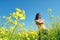 Happy girl on sunny flower field