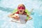 Happy girl swimming in pool with ring and laptop