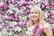 Happy girl woman with a bouquet on a background of blooming lilacs