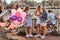 Happy girlfriends conversation together at picnic party outdoor. Scene of a celebrating a birthday at the outdoor park.