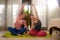 Happy girlfriends yoga workout at home - two beautiful Asian women practicing yoga and meditation together enjoying exercise in