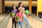 Happy girls with balls in bowling