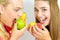 Happy girls eating fruits