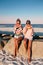 Happy girls eating watermelon on the beach. Friendship, happiness, beach, summer concept.