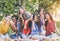 Happy girls eating watermelon at picnic dinner in the garden - Young women having fun enjoying lunch together in the backyard