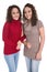 Happy girls: Portrait of real female twins wearing winter pullover.