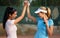 Happy girls on tennis court