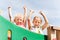 Happy girls waving hands on children playground