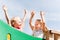 Happy girls waving hands on children playground